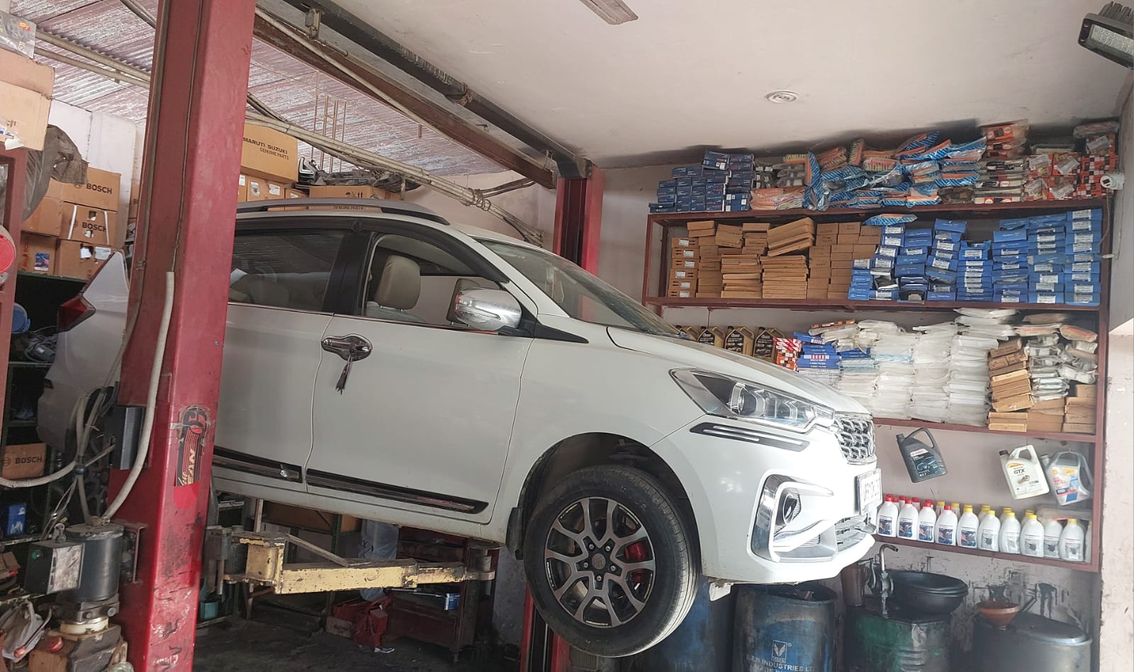 Car raised on the workshop lift for body and underbody work