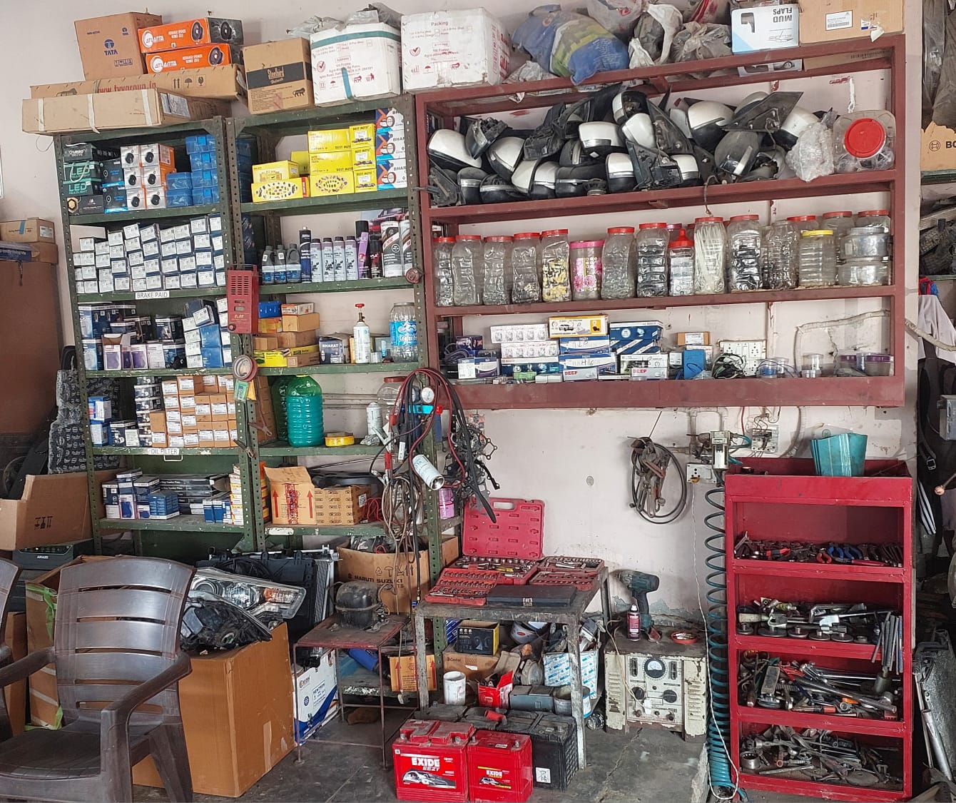 Workshop tool wall with parts, batteries and hand tools